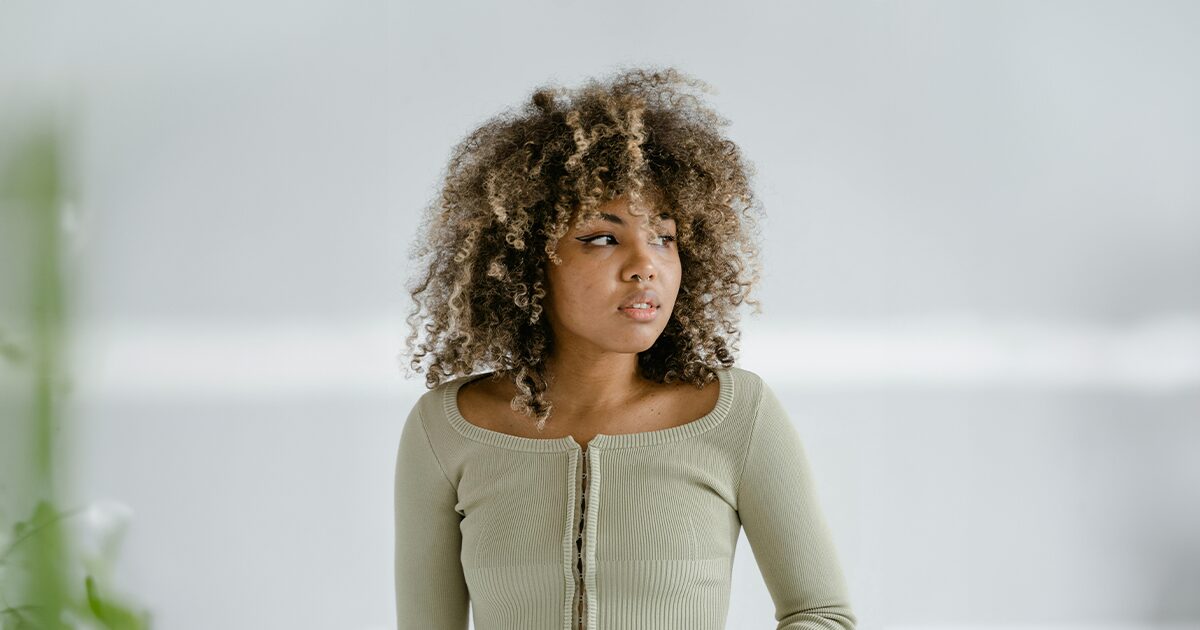 Woman considering her pregnancy options while facing financial concerns about an unexpected pregnancy.