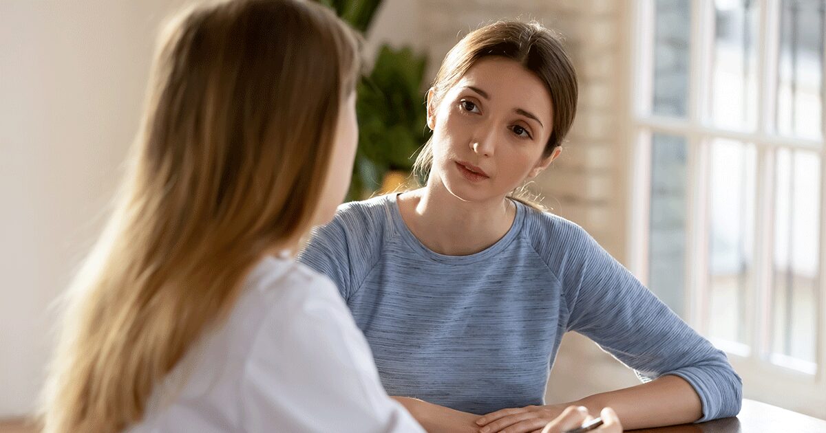 Healthcare provider talking with a woman about abortion procedures and pregnancy options.